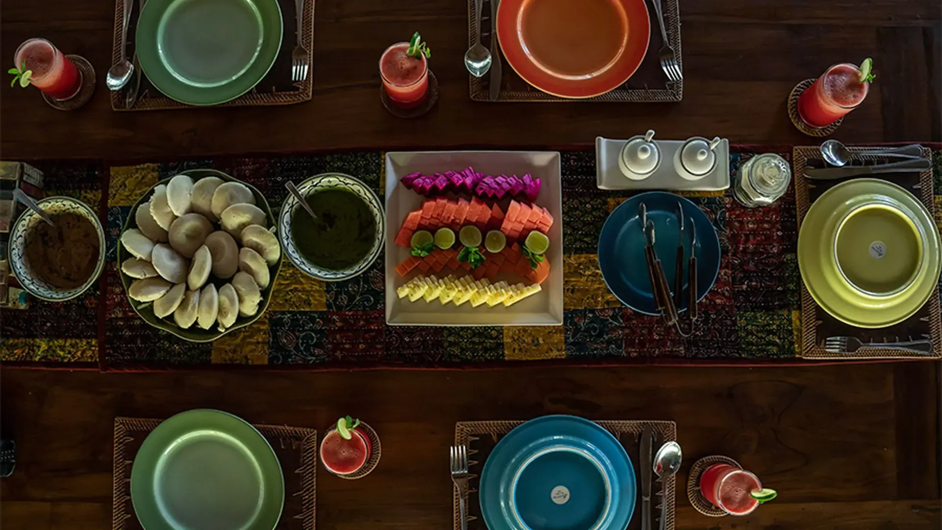Breakfast table at Annam set with idli, chutneys, fresh tropical fruit and juices